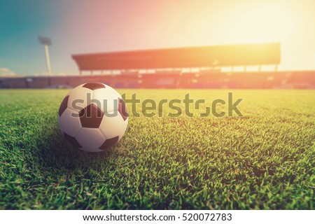 Soccer ball on grass in soccer stadium. soccer ball on sunset