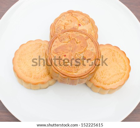 Moon cakes placed on a white plate.