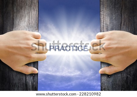 Practice word floating and shining in the sky while two hands opening an old wooden door Practice word floating and shining in the sky while two hands opening an old wooden door