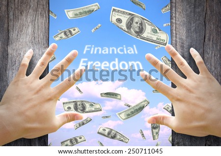 Financial Freedom concept. Opening a door and see many dollar bills floating in the sky. Financial freedom wording in the middle.