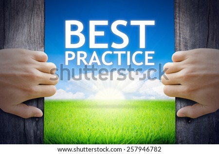 Best Practice. Hand opening an old wooden door and found Best Practice word floating over green field and bright blue Sky Sunrise.