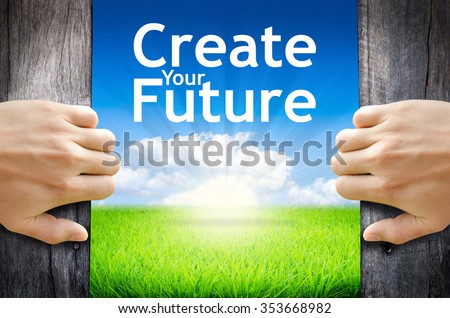 Create your future. Hand opening an old wooden door and found wording \