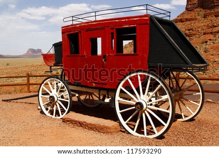 Old stage coach in front of the fantastic shapes of the vast sandstone buttes of Monument Valley, part of the Colorado Plateau in the Navajo Nation Reservation, from Gouldings Lodge, Utah, USA