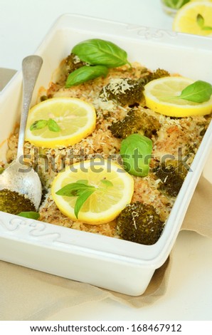 baked coconut and broccoli fish with a fresh sliced lemon