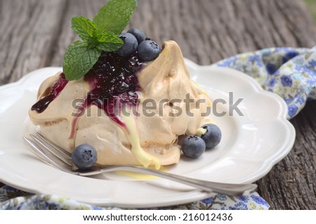 coffee meringue with a cream and fresh blueberries