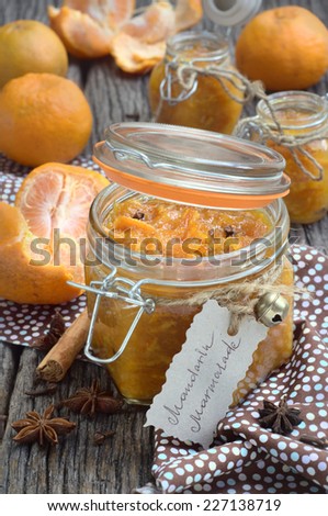 homemade mandarin marmalade with cinnamon, anise and glove in a glass jar