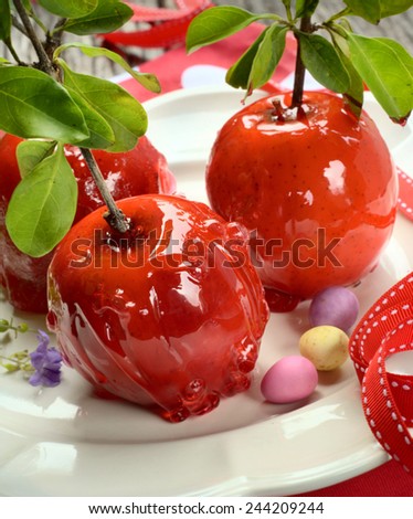Red Toffee Apples on a White Plate. Selective Focus