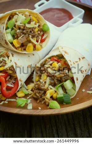 beef mince burritos on a bamboo plate. selective focus
