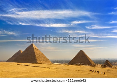 Egypt. Cairo - Giza. General view of pyramids from the Giza Plateau (from left: the Pyramid of Chufu /Cheops/, Khafre, Menkaure /Mykerinos/ and one of the small pyramids known as Queens\' Pyramids)