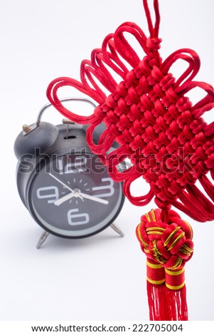 Chinese knot and alarm clock Isolated on white