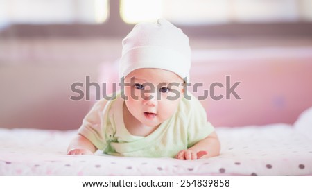 a soft focus picture of new born baby who try to creeping and crawling.