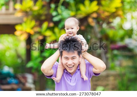 Father playing with daughter and try to take his baby sit on his neck.