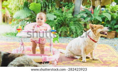 6 month baby and her dog. Pets can improve social skills in children.