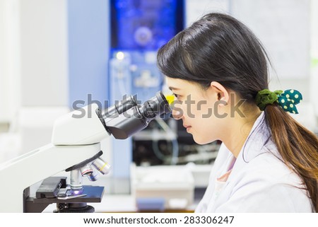 medical technologist is working in the laboratory. Using a microscope for detect the objects that are too small for the naked eye.