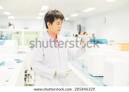 medical technologist is working in the laboratory, analyzing the blood tube.