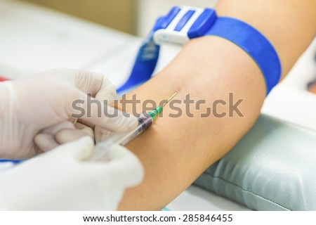 Medical technologist doing a blood draw services for patient.