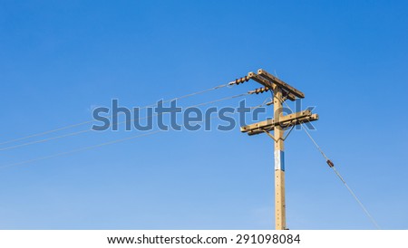 Utility pole supporting wires for electrical power distribution, coaxial cable for Cable TV, and telephone cable.