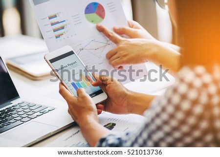 Two business woman investment consultant analyzing company annual financial report balance sheet statement working with documents graphs. Concept picture of business, market, office, tax.