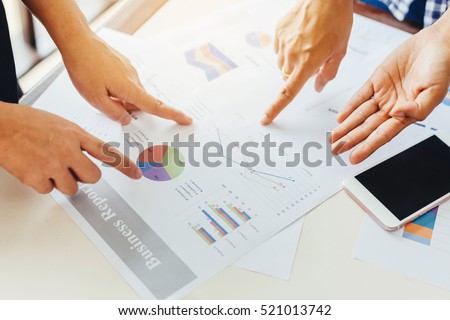 Two business woman investment consultant analyzing company annual financial report balance sheet statement working with documents graphs. Stock market, office, tax, concept. Hands with charts papers.
