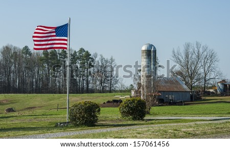 Classic storage silos on a working farm with American Flag in the yard