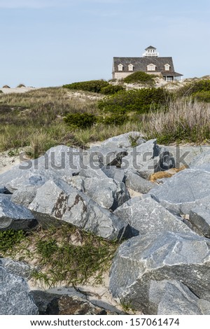 Old guard house on the Atlantic ocean, with rocky shore.