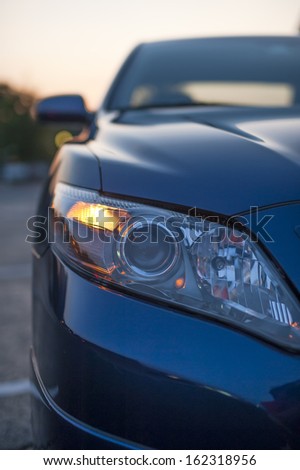 blue modern car closeup of headlight