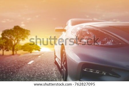 Car traveling in nature on an asphalt road - Front view