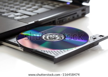 Inserting a blank CD or DVD into a laptop computer