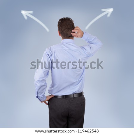 Arrow signs showing two different directions with a businessman scratching his head concept for confusion, choice and decisions