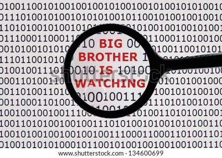 Internet security concept the words big brother is watching on a digital tablet screen with a magnifying glass