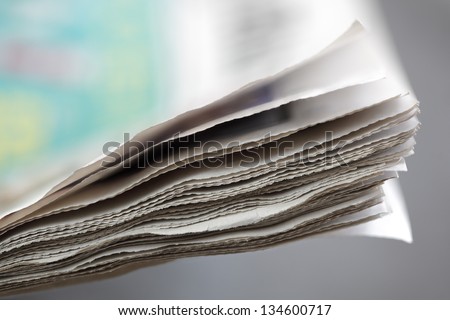 Newspaper concept edge of newspaper pages with shallow depth of field