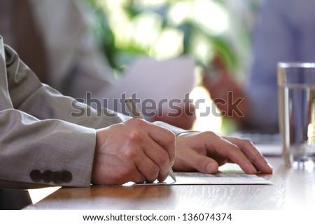 Business meeting or lecture with businessman writing or signing contract