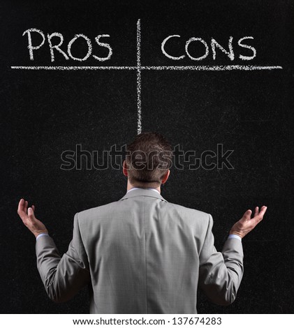 Businessman with blackboard list of pros and cons, for and against argument concept