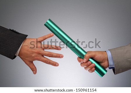 Partnership Or Teamwork Concept Two Businessmen Handing Over A Baton