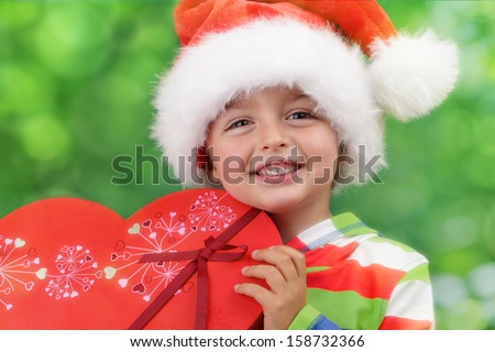 Christmas excitement - ecstatic young boy on christmas morning holding a present