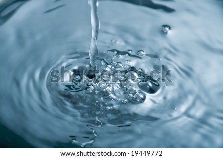 Water being poured producing bubbles and ripples