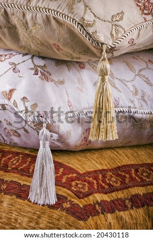 Three ornate cushions, home furnishing background texture