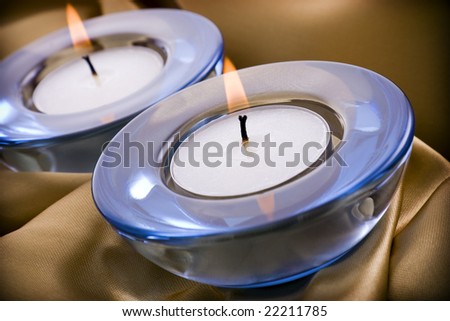 Tealight candles on a gold satin textile background