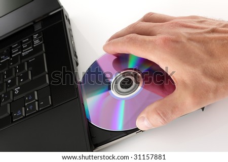 Loading a DVD or CD into a laptop computer
