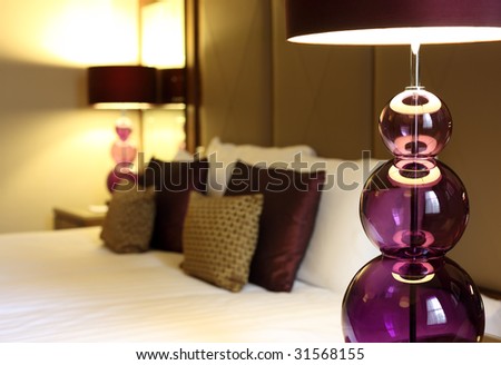Abstract luxury hotel room with focus on foreground electric lamp