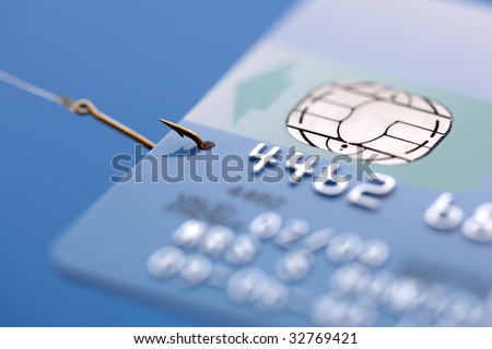 Credit card caught on a fishing hook concept for addiction to spending with credit or phishing