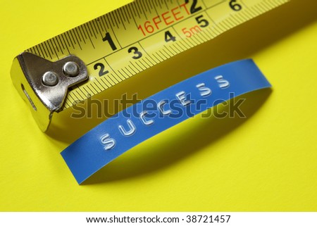 Measurement of success concept - tape measure against a label reading success