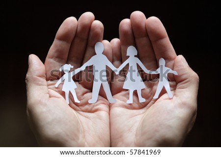 stock photo : Cutout paper chain family with the protection of cupped hands, concept for security and care