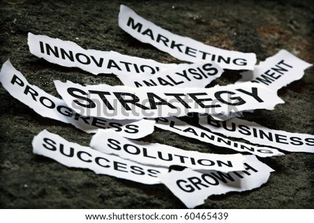 Torn newspaper headlines depicting business strategy