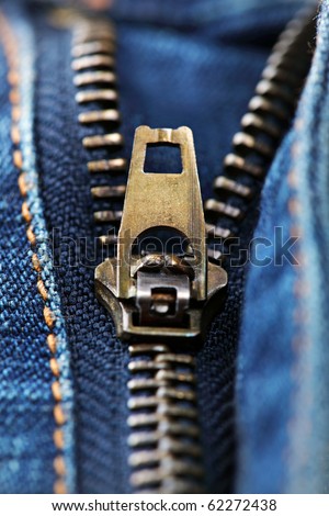 Close up of a zip on a pair of blue jeans half unzipped