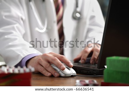 Doctor using a laptop computer to prepare an online prescription