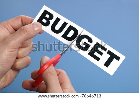 Scissors cutting the word budget concept for recession or credit crisis