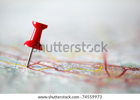 Red pushpin showing the location of a destination point on a map Red pushpin showing the location of a destination point on a map