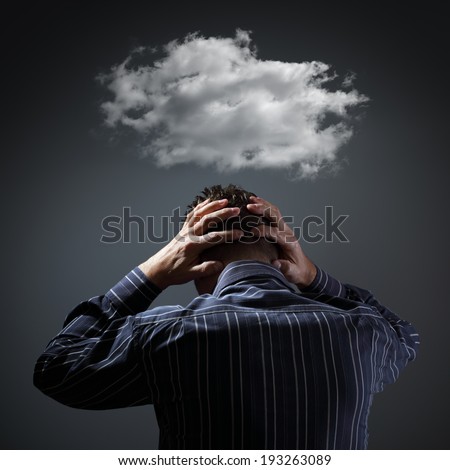 Stress, depression and despair - gloomy storm cloud above mans head
