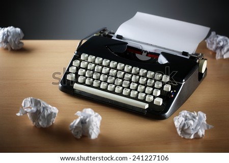 Frustration stress and writers block with old typewriter on desk and crumpled paper ball